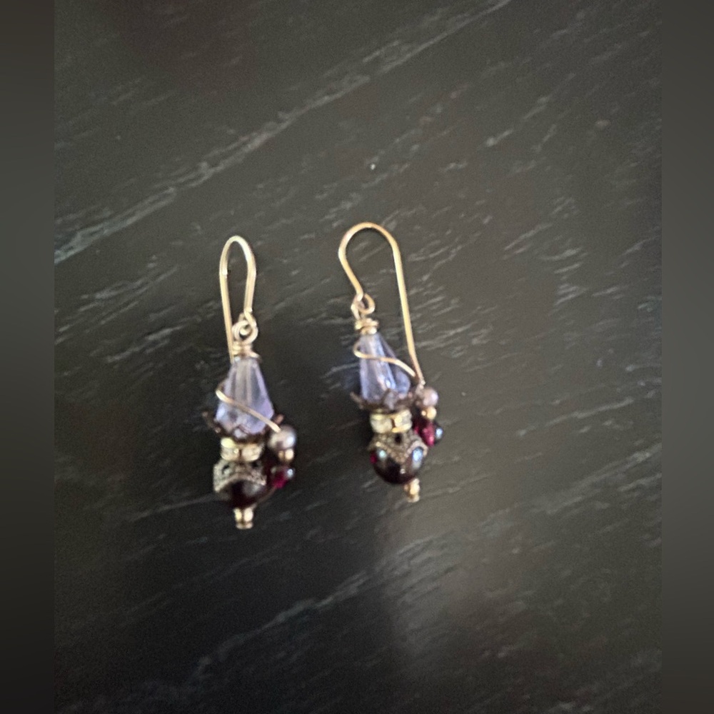 Purple crystal stone with a darker purple bead on gold hook wire pierced